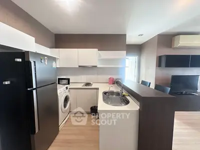 Modern kitchen with sleek appliances and open layout in stylish apartment