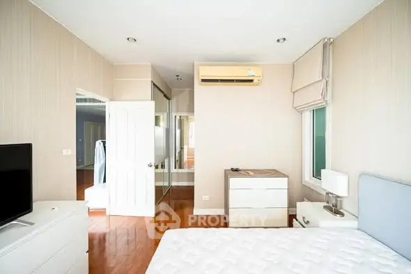 Spacious bedroom with modern decor and ample natural light