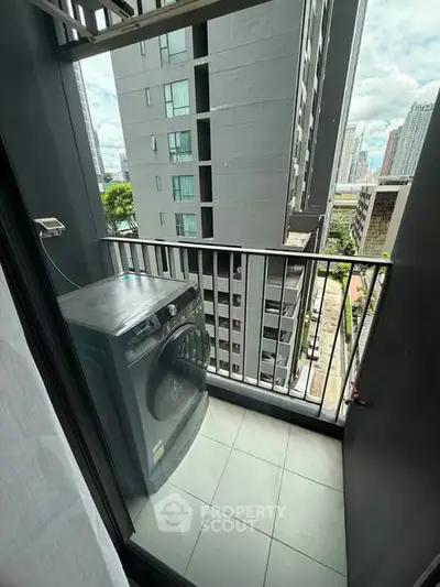 Modern apartment balcony with city view and washing machine, perfect for urban living.