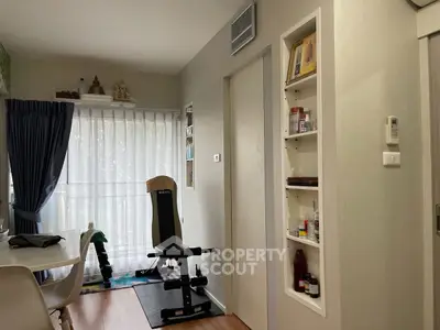 Cozy living space with exercise equipment and built-in shelving