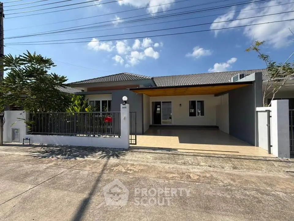 Charming single-story home with spacious driveway and modern exterior design, perfect for family living.