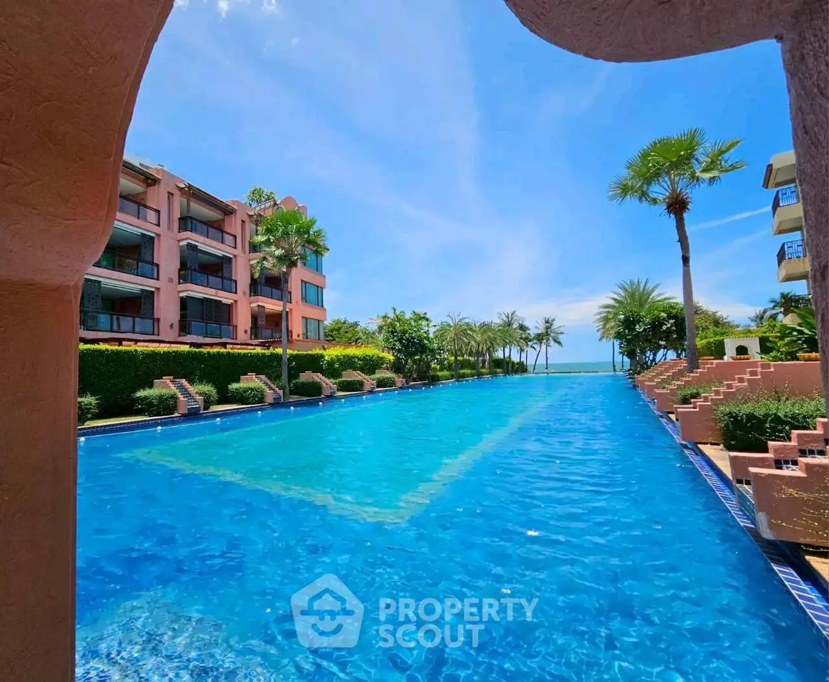Luxurious beachfront property with stunning pool and ocean view, perfect for relaxation and leisure.