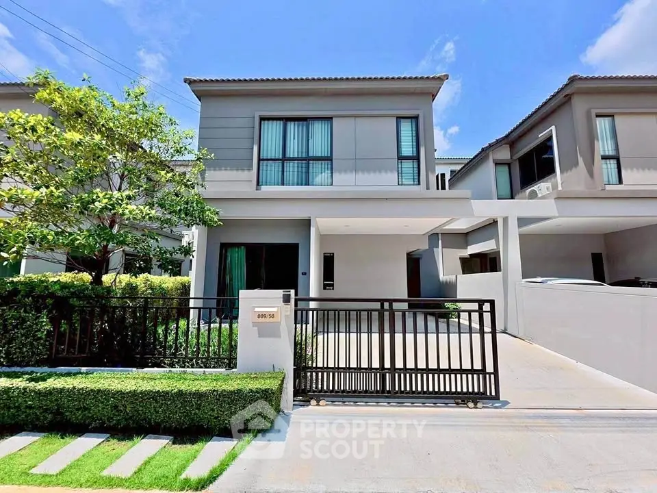 Modern two-story house with sleek design and spacious driveway in a serene neighborhood.