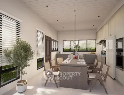Modern kitchen with sleek design, featuring open layout and elegant dining area.