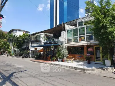 Charming street view with modern buildings and lush greenery, perfect for urban living.