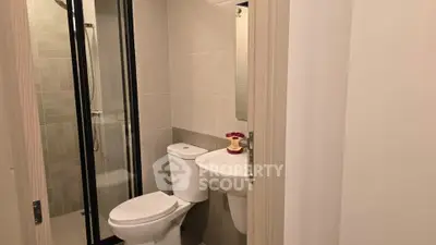 Modern bathroom with sleek fixtures and glass shower enclosure