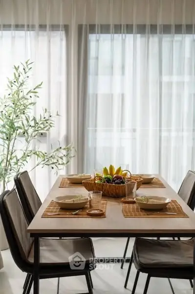 Elegant dining area with modern chairs and a fruit centerpiece, perfect for family gatherings.