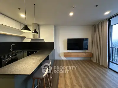 Modern open-layout kitchen and living room with sleek design and city view.