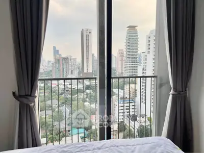 Stunning city view from a modern bedroom with floor-to-ceiling windows and elegant curtains.