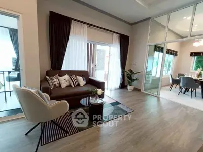 Spacious modern living room with elegant decor and large windows for natural light.