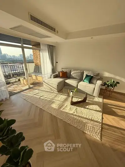 Spacious living room with modern decor and large balcony offering stunning city views.