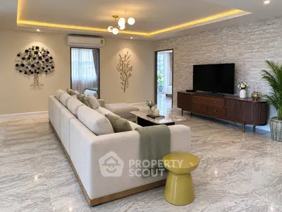 Luxurious living room with modern decor, spacious seating, and elegant lighting, perfect for relaxation and entertainment.
