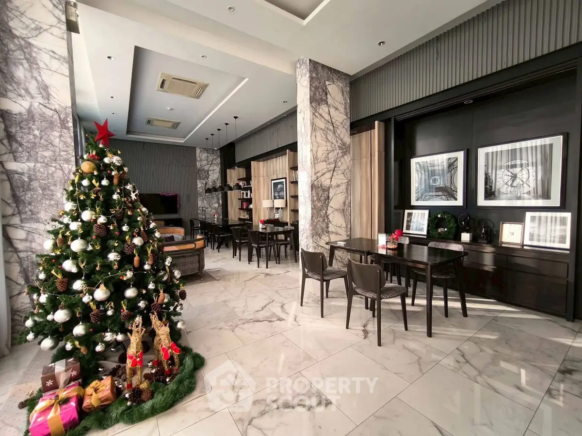 Luxurious marble-floored lobby with festive Christmas decor and elegant seating area.