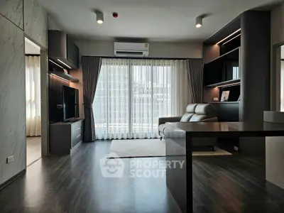 Modern living room with sleek design and large windows offering natural light.
