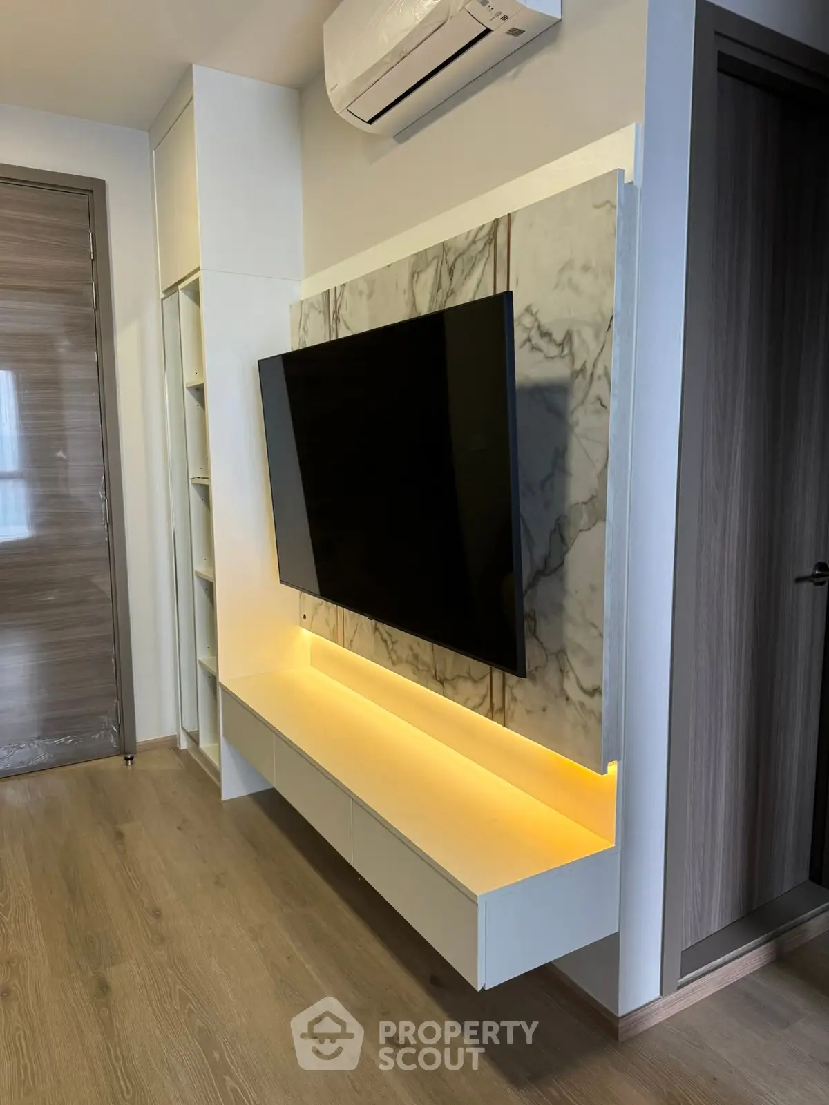 Modern living room with wall-mounted TV and ambient lighting