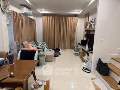 Spacious living room with modern decor and ample natural light