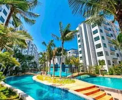 Luxurious residential complex with stunning pool and lush palm trees