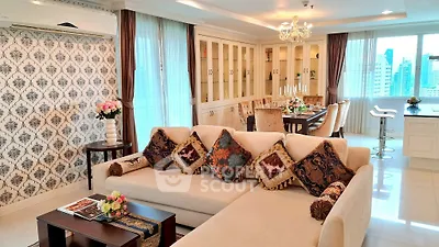 Luxurious living room with elegant decor and city view, featuring a spacious dining area and modern kitchen.