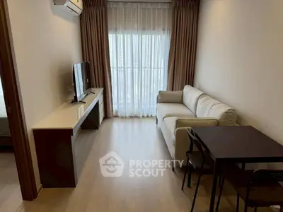 Modern living room with natural light, featuring a cozy sofa, sleek TV stand, and elegant curtains.