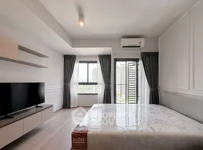 Modern bedroom with city view, featuring sleek design and natural light, perfect for urban living.