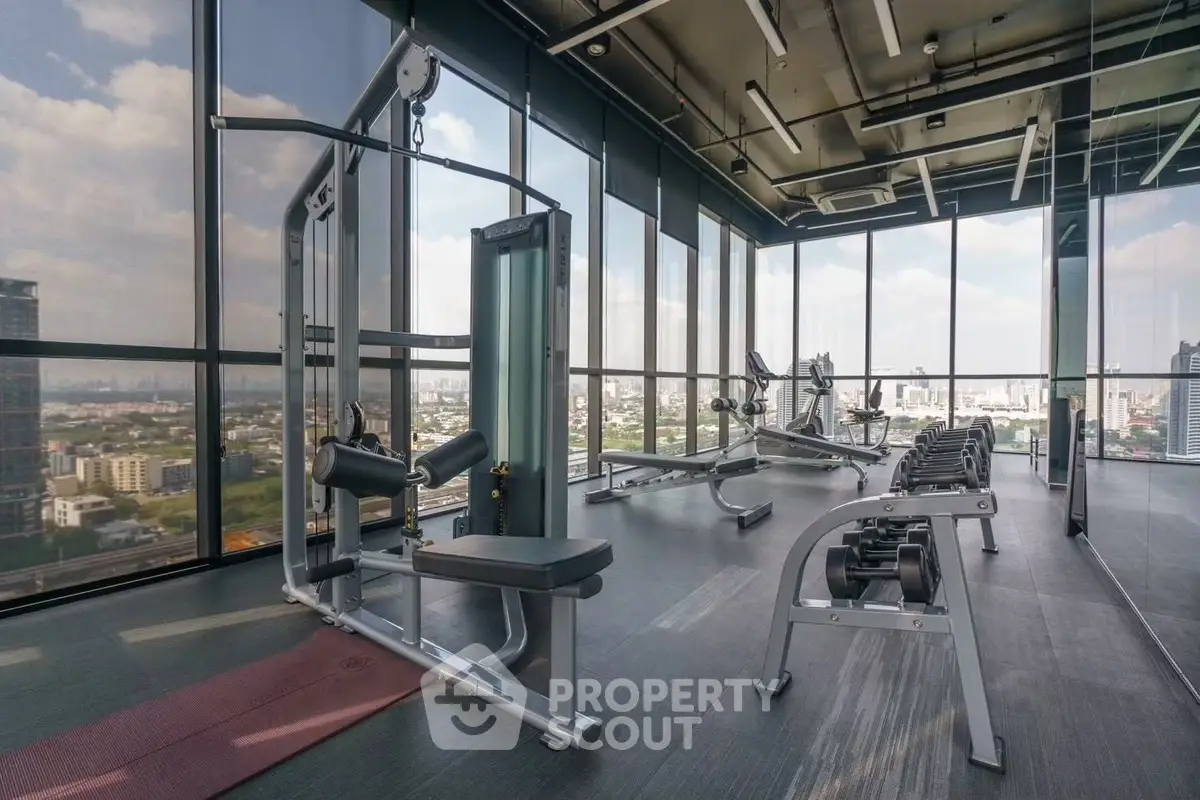 Modern gym with panoramic city views and state-of-the-art fitness equipment.