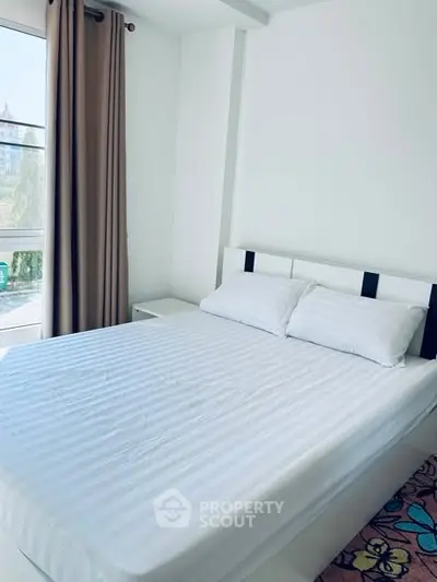 Bright and cozy bedroom with large window and modern decor