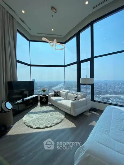 Luxurious high-rise living room with panoramic city views and modern decor.