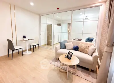Modern living room with cozy seating and elegant decor in a stylish apartment.