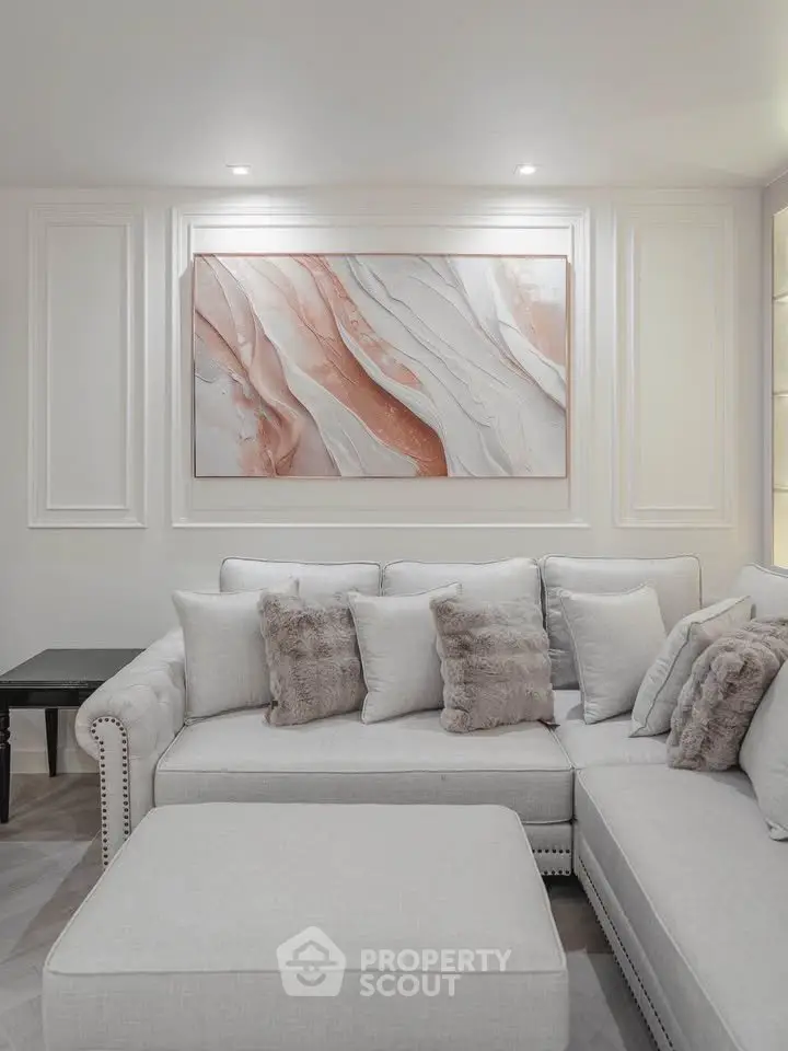 Elegant living room with plush sectional sofa and modern art decor, perfect for stylish relaxation.