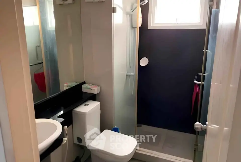 Compact modern bathroom with shower and sleek fixtures