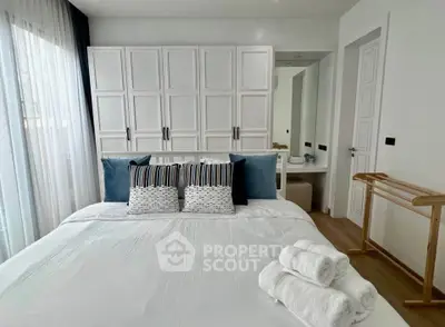 Elegant bedroom with stylish decor and ample storage in modern apartment