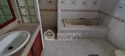 Spacious bathroom with bathtub and elegant tile design