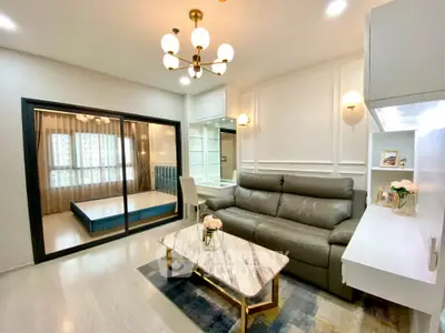 Elegant living room with glossy marble flooring, modern furniture, and chic lighting fixtures, complemented by a serene bedroom view.