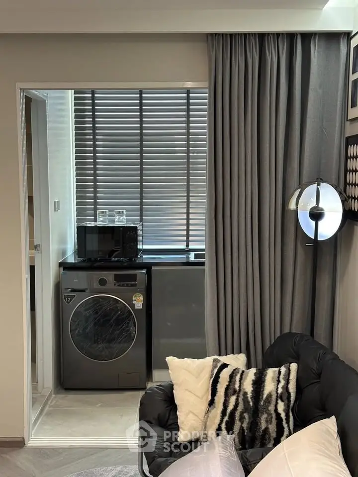 Modern living room with stylish decor and compact laundry area