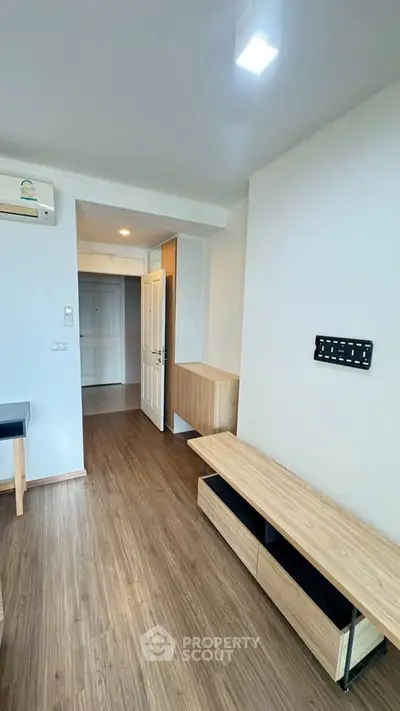 Modern apartment interior with wooden flooring and minimalist furniture