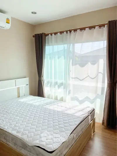 Bright bedroom with large window and modern decor