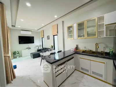 Modern open-layout kitchen and living room with sleek design and natural light