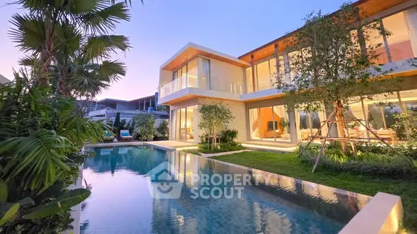 Luxurious modern villa with stunning pool and lush garden at sunset, perfect for upscale living.