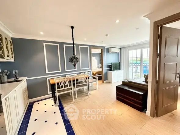 Stylish open-plan living and dining area with modern decor and ample natural light.