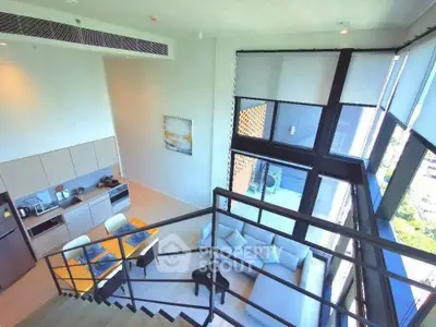 Modern loft apartment with open layout and large windows offering stunning city views.