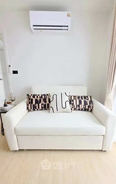 Modern living room with stylish sofa and air conditioning unit, perfect for cozy relaxation.