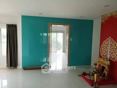 Spacious living room with modern glass door and vibrant decor