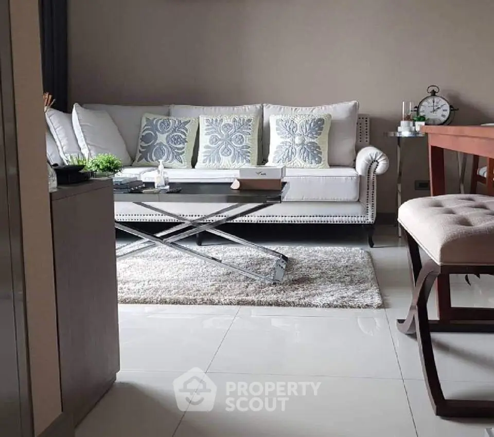 Stylish living room with elegant sofa and modern decor in a cozy apartment setting.