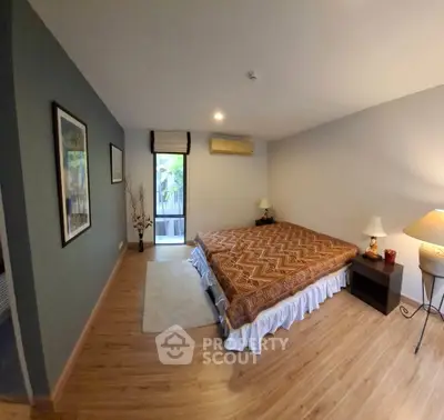 Spacious bedroom with elegant decor and natural light