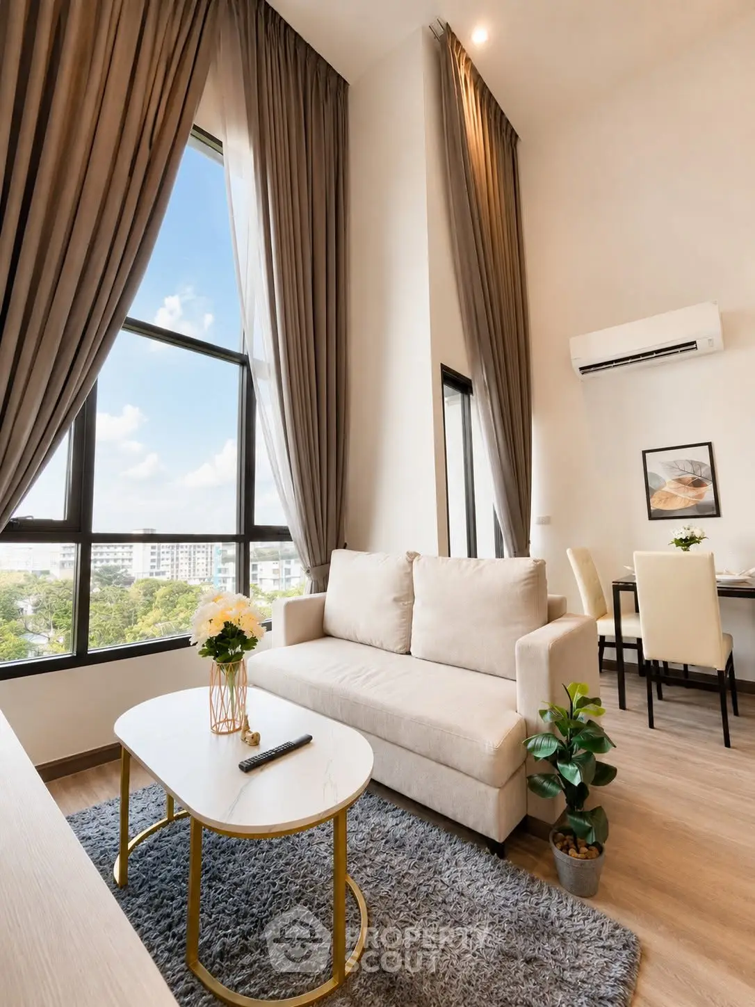 Luxurious high-ceiling living room with large windows and elegant decor