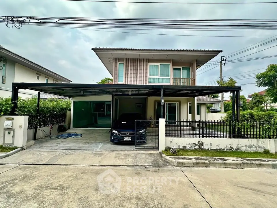 Modern two-story house with carport in a suburban neighborhood, featuring a sleek design and well-maintained exterior.