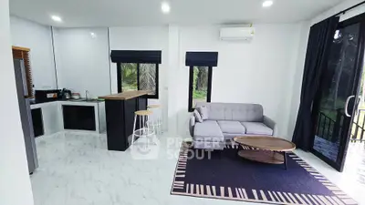 Modern open-plan living room with sleek kitchen and stylish furniture