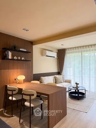 Modern living room with stylish furniture and large window for natural light