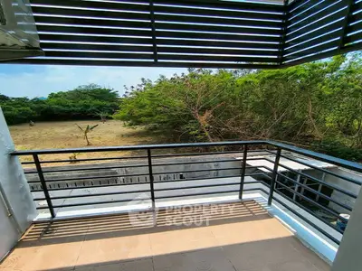 Charming balcony with lush greenery view, perfect for relaxation and enjoying nature.