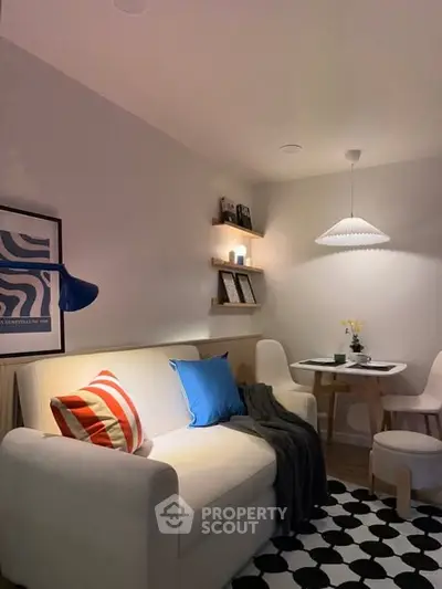 Cozy living room with modern decor and dining area, perfect for small gatherings.